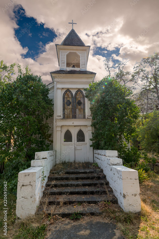 Small catholic church in the Idaho that is weathered and rundown