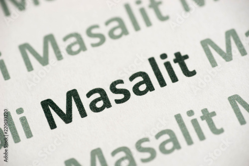 word Masalit language printed on paper macro photo