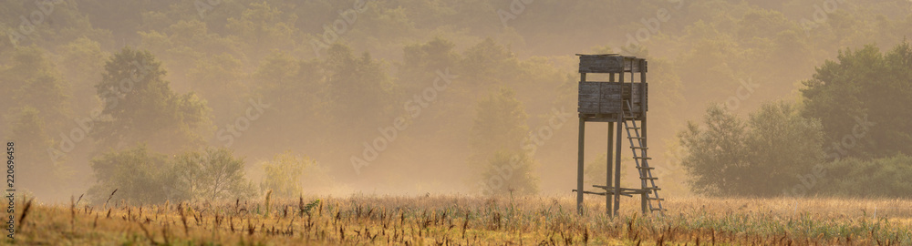 hunting tower in the valley in the morning mists - obrazy, fototapety, plakaty 