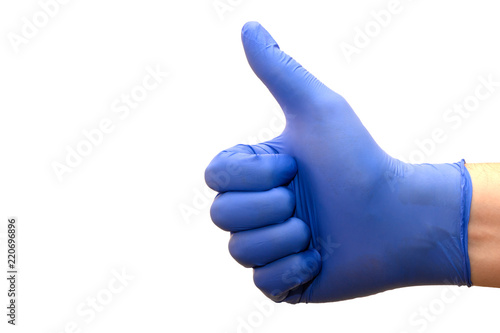 Closeup of a male hand in a blue medical glove showing a thumbs up on a white background.