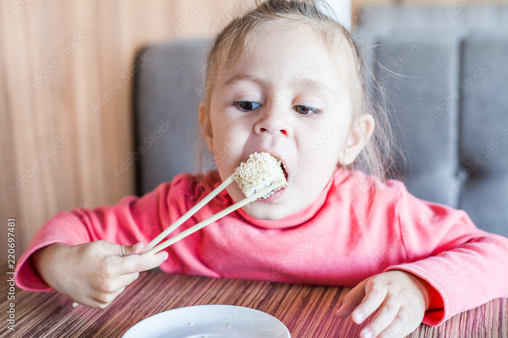 little girl eating sushi chopsticks little girl eating sushi chopsticks