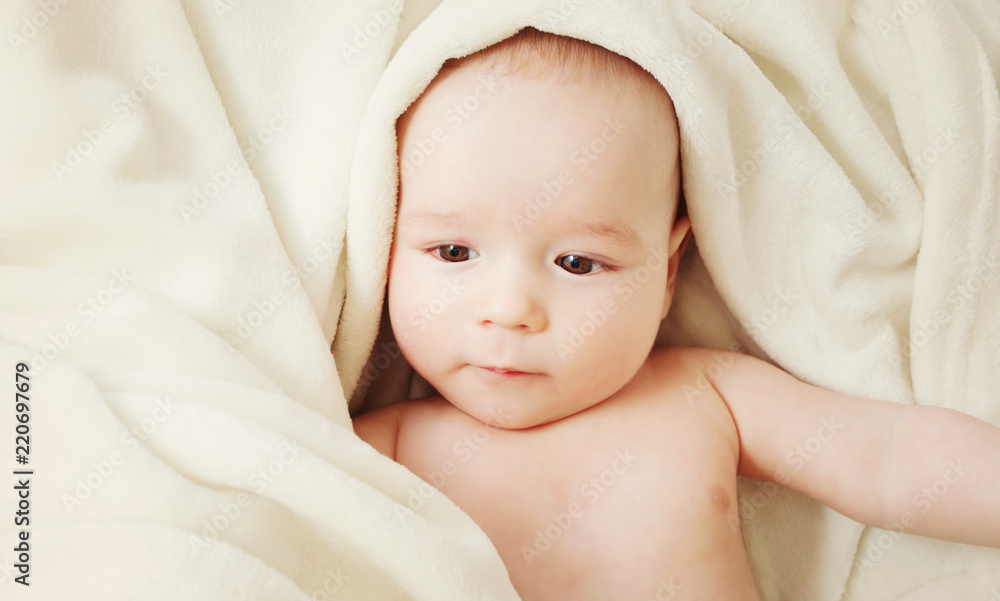 cute baby lying in bed covered with soft blanket cute baby lying in bed covered with soft blanket