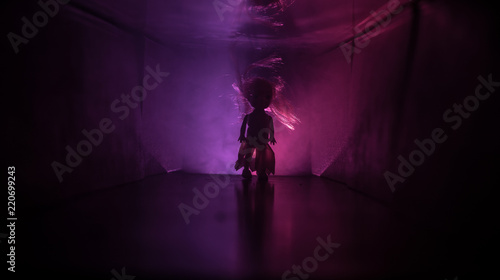 Creepy silhouette in the dark abandoned building. Horror about maniac concept or Dark corridor with cabinet doors and lights with silhouette of spooky horror person