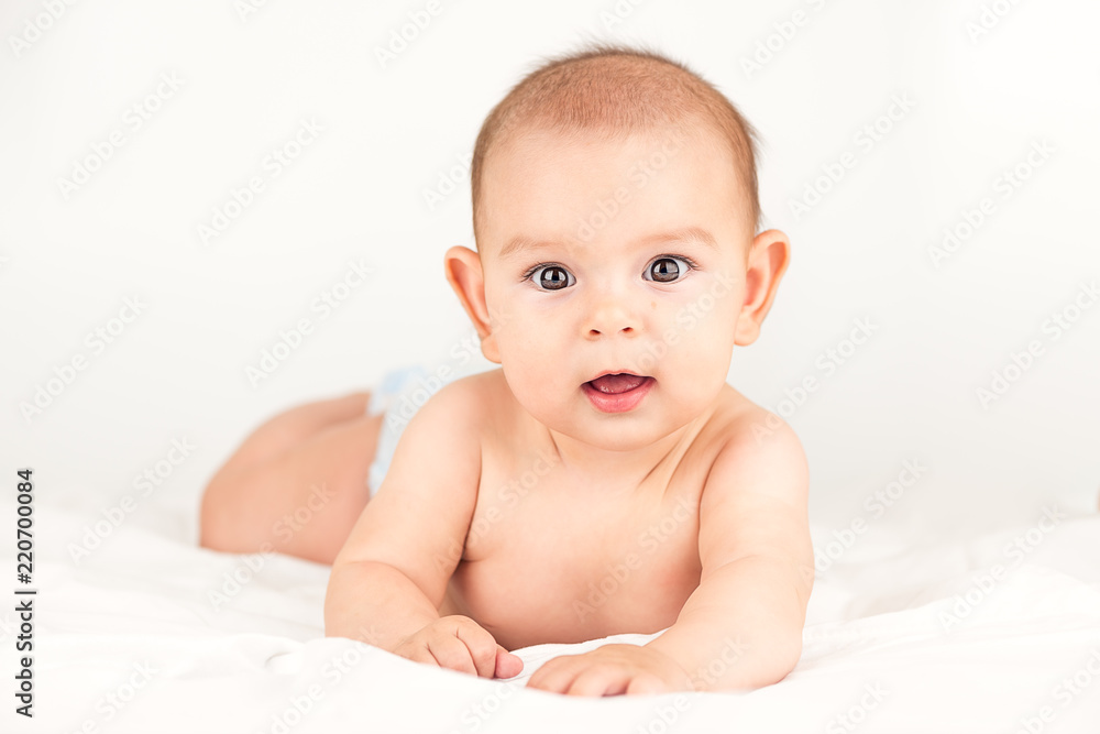 smiling happy newborn infant baby tummy time on bed bright airy copy space childhood smiling happy newborn infant baby tummy time on bed bright airy copy space childhood