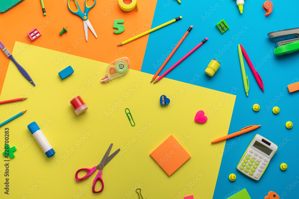School supplies on a multi-colored background