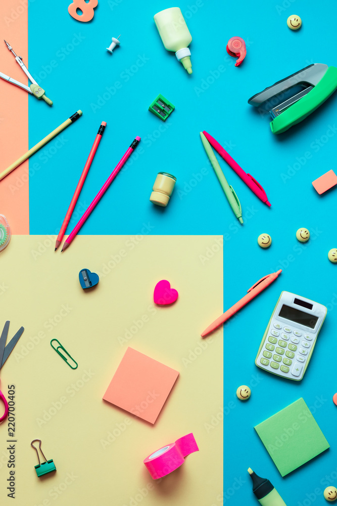 School supplies on a multi-colored background