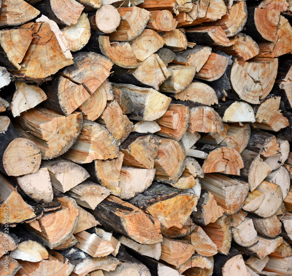 Woodpile end of tightly packed chopped logs Woodpile end of tightly packed chopped logs