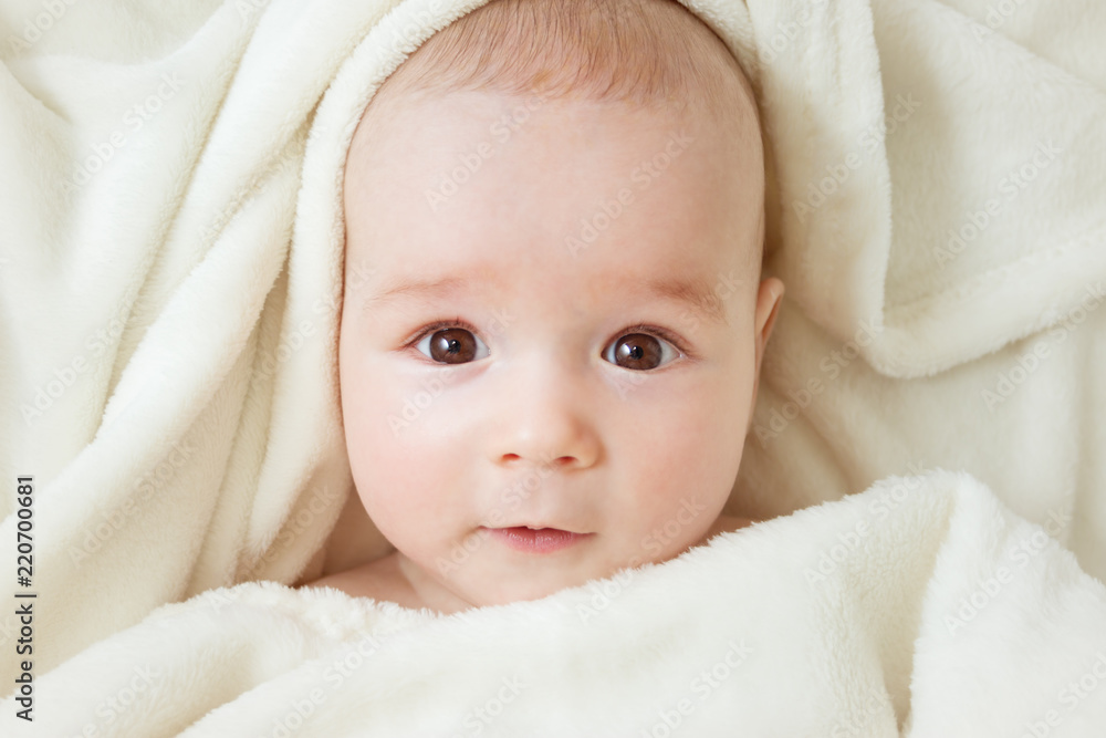 cute baby lying in bed covered with soft blanket cute baby lying in bed covered with soft blanket