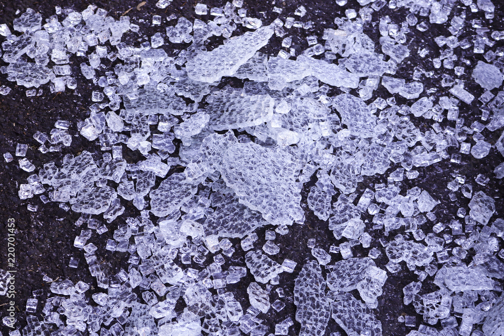 broken transparent glass, covered with dust. small pieces of glass shine and shimmer, reflecting the rays of light. broken transparent glass, covered with dust. small pieces of glass shine and shimmer, reflecting the rays of light.