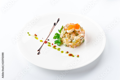 Olivier with mushrooms in a white plate, isolated on a white background. View from above, apartment. Close-up