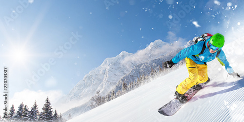 Man snowboarder riding on slope.