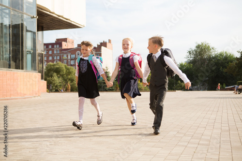Group of little school kids going to school together.