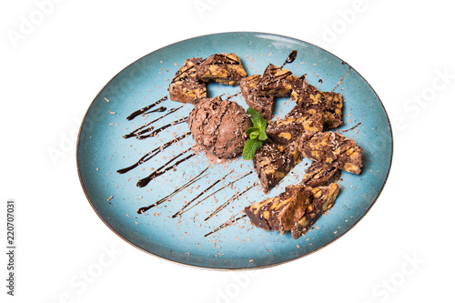 chocolate brownie and ice cream on a plate isolated on a white background