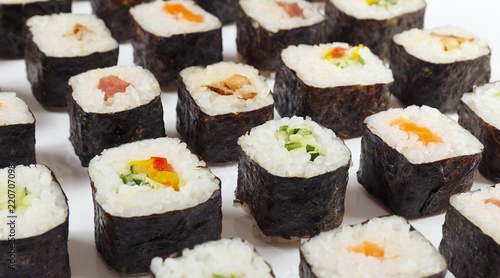 Assorted traditional sushi on a white background close up.