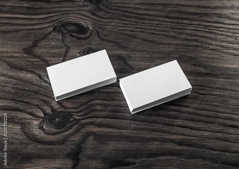 Fototapeta premium Photo of blank business cards on wood table background. Template for ID.