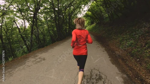 Wallpaper Mural Running girl. Blonde girl doing outdoor sports in the summer forest. Rear view slow-motion wide angle Torontodigital.ca