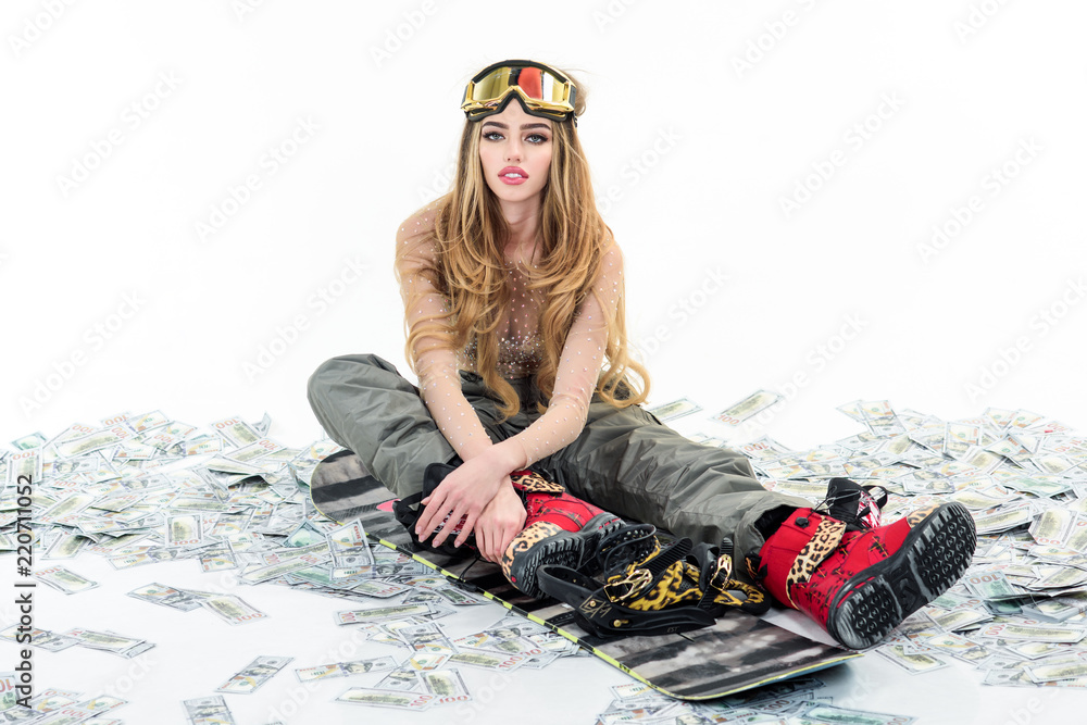 Winter sport, snowboarding. Snowboard girl sits on dollars. Dollars cash.  Woman wears sexy clothes. Sexy sportswoman with snowboard. Snowboard girl. Ski  mask. Winter, leisure, extreme, money, finances Stock Photo | Adobe Stock