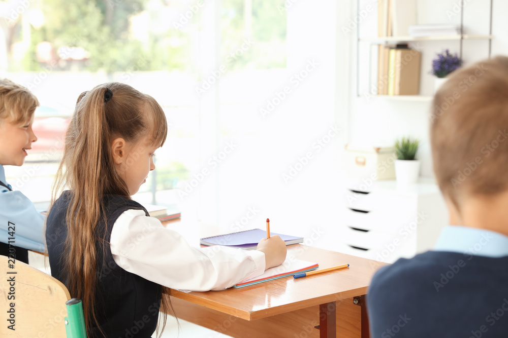 Little children in classroom. Stylish school uniform Little children in classroom. Stylish school uniform