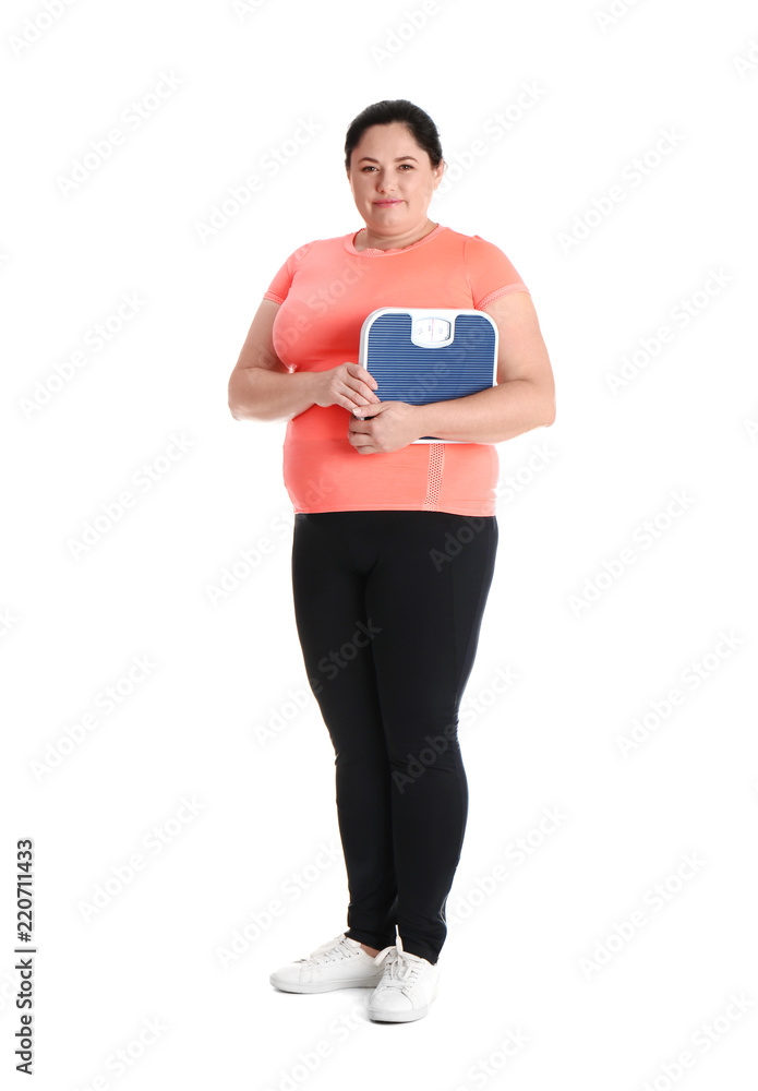 Overweight woman in sportswear with scales on white background