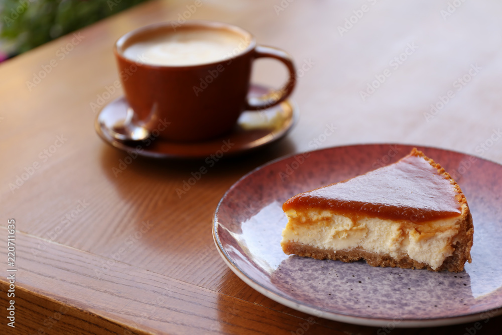 Plate with slice of cake on wooden table Plate with slice of cake on wooden table