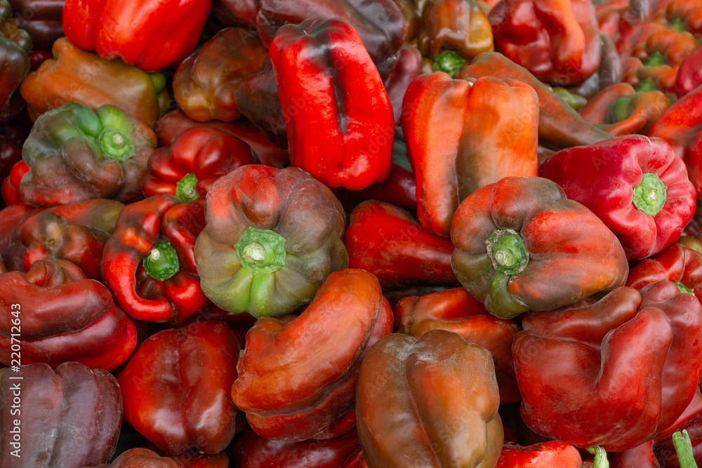 A large number of red peppers. Background.