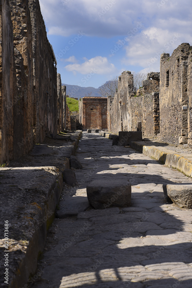 Paved Street in the once buried Roman city of Pompeii south of Naples under the shadow of Mount Vesuvius Italy
