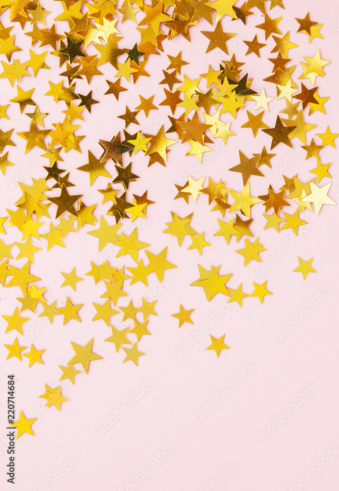 Yellow stars confetti on pink background.