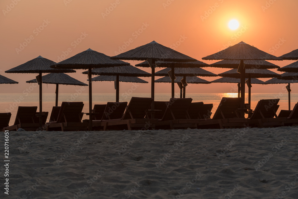 Sun beds and umbrellas on the beach Sun beds and umbrellas on the beach