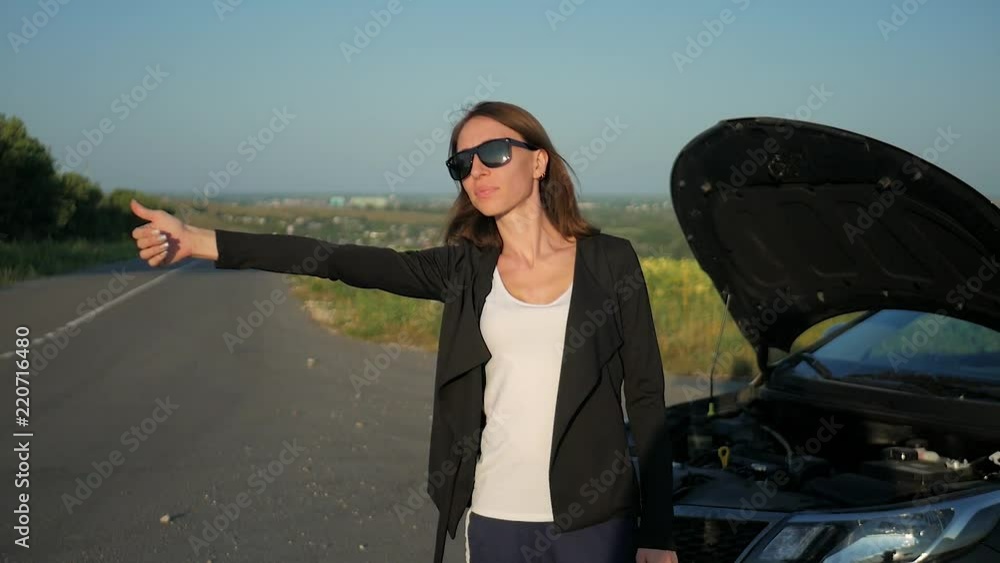 young girl with a broken car with open hood young girl with a broken car with open hood