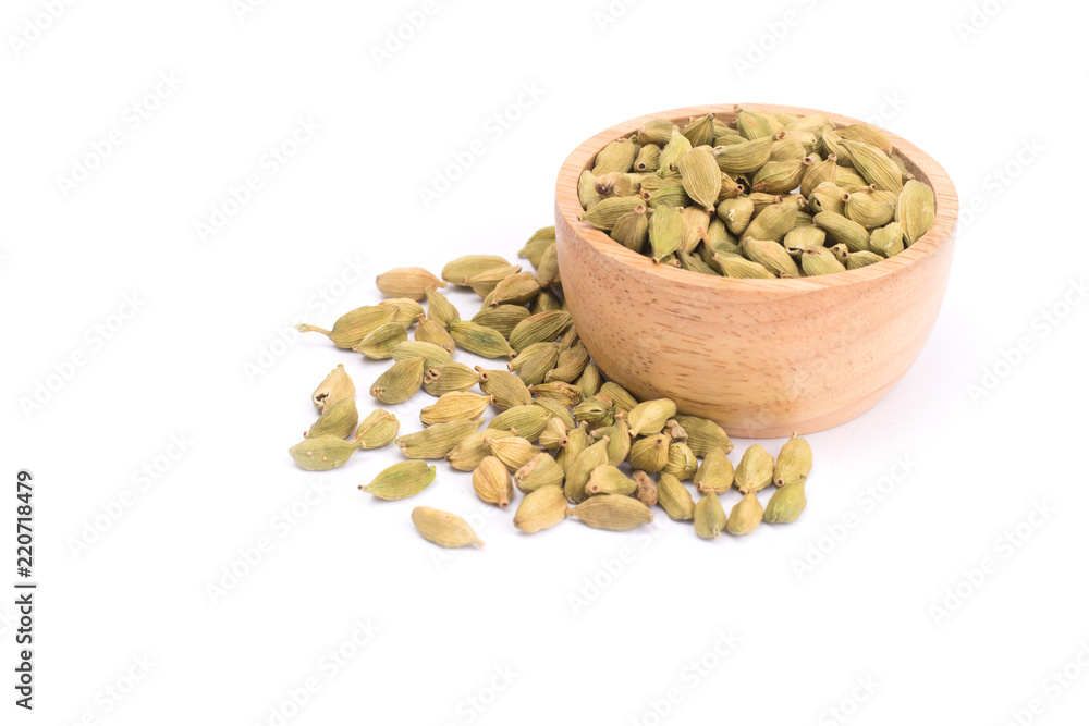 Green Cardamom in wooden bowl, cardamon or cardamum isolated on white background (dried fruits of Elettaria cardamomum Green Cardamom in wooden bowl, cardamon or cardamum isolated on white background (dried fruits of Elettaria cardamomum