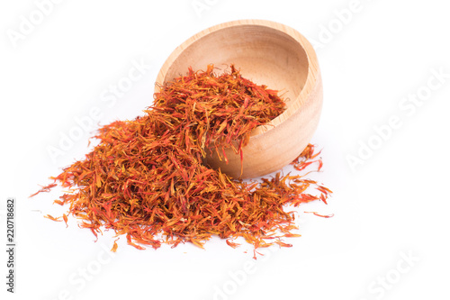 Dried safflower in wooden bowl isolated on white background