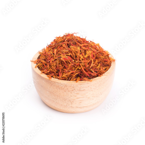 Dried safflower in wooden bowl isolated on white background