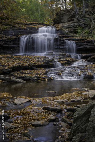 Autumn Leaves Cover Rocks Surrounding a Waterfall in Ricketts Glen State Park in Pennsylvania