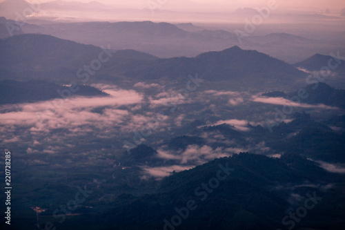Background, high angle from the passenger plane. You can see the scenery by the distance (mountains, rivers, sky, fog, houses), the photos may be blurred during the flight. © bangprik