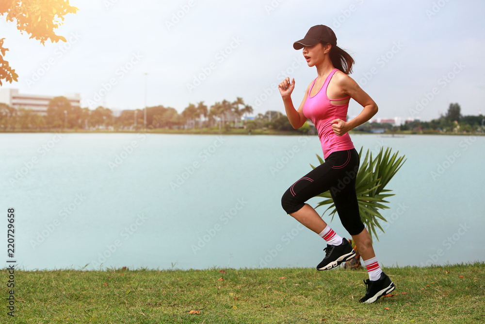 Sporty female jogger morning exercise on seaside on grass. vintage tone Sporty female jogger morning exercise on seaside on grass. vintage tone