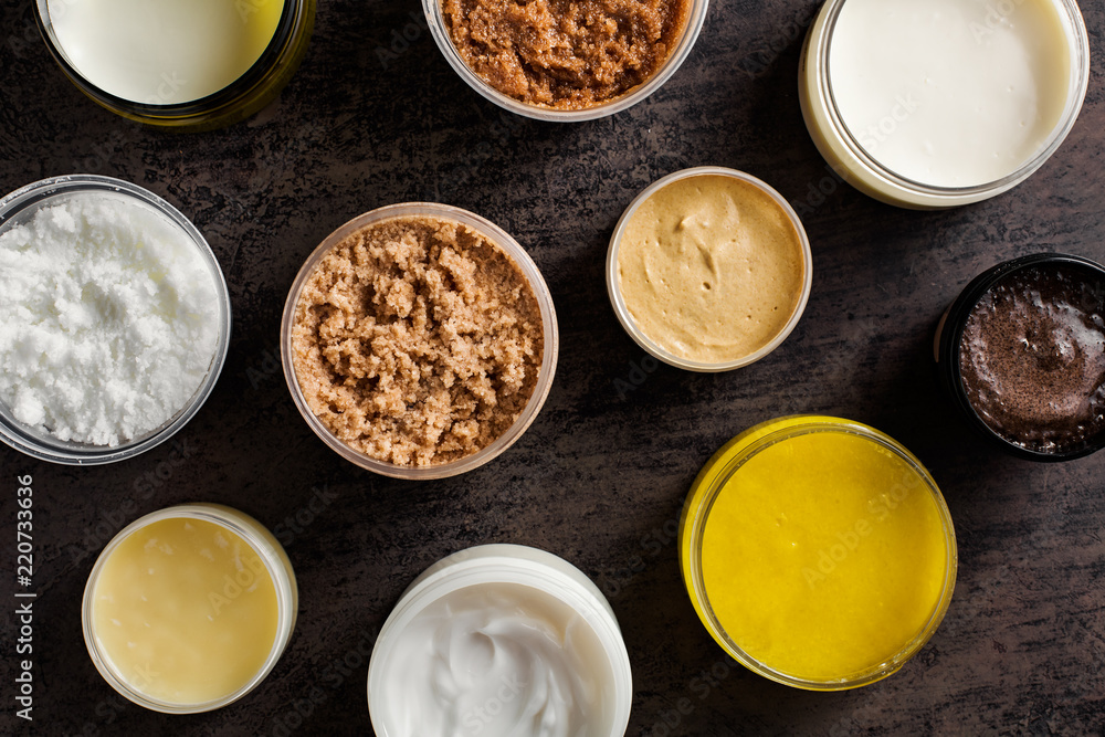 A set of different scrubs and body creams, top view. A set of different scrubs and body creams, top view.