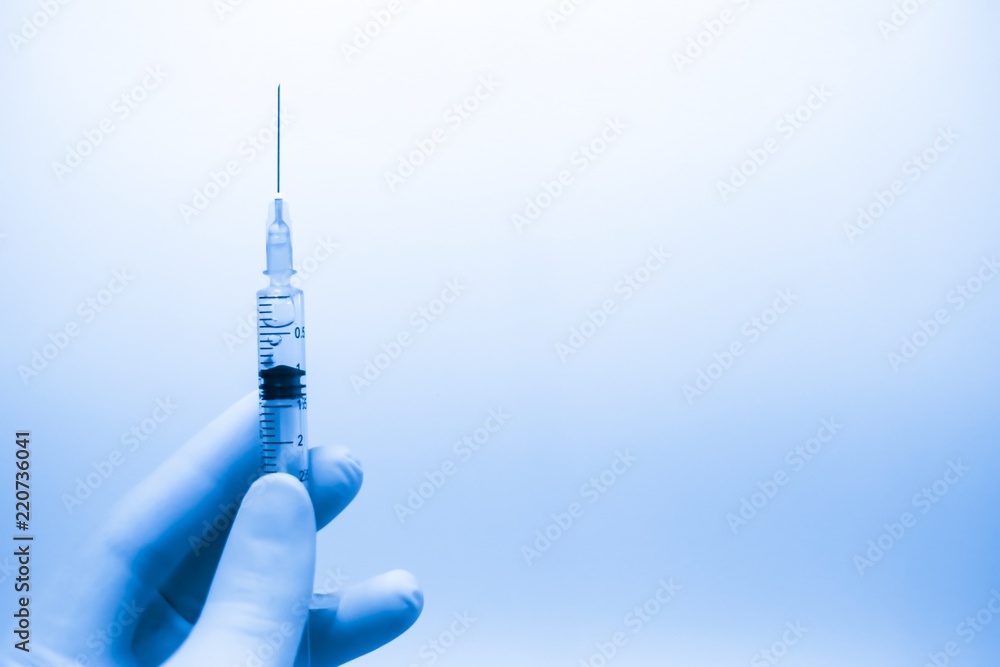 Medical hand gloves dispose drug insulin needle syringe,concept flu shot vaccine vial dose hypodermic injection treatment disease hospital,prevention immunization.baby children.selective focus Medical hand gloves dispose drug insulin needle syringe,concept flu shot vaccine vial dose hypodermic injection treatment disease hospital,prevention immunization.baby children.selective focus