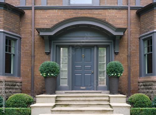 elegant front door with shrubbery