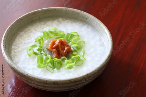 Japanese rice porridge with pickled ume "umeboshi" and some chopped spring onion.