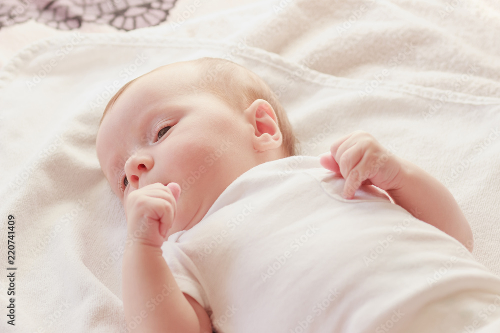 Smiling baby on the bed, soft focus background Smiling baby on the bed, soft focus background