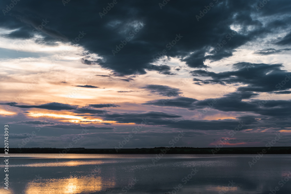 Sunset at the lake with sky reflecting in water