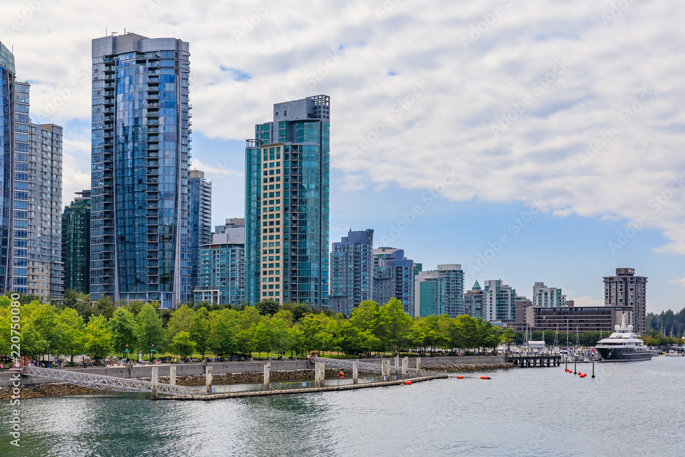August 04, 2018 - Vancouver, Canada: Coal Harbor with downtown buildings, boats and reflections in the water