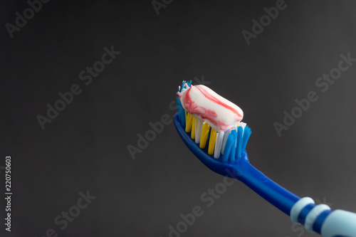 Toothbrush on a black background with selective focus and crop fragment