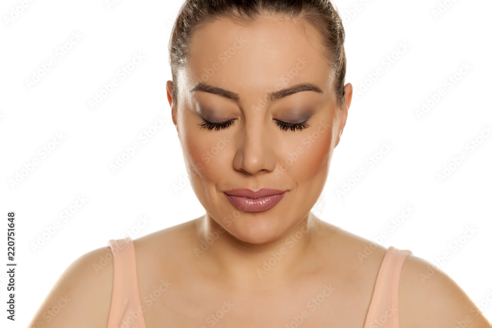 Portrait of beautiful woman with closed eyes on white background Portrait of beautiful woman with closed eyes on white background