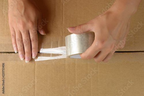 woman's hands pack the box for relocation. copyspace