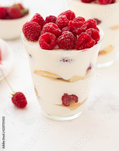 Raspberry dessert  cheesecake  raspberry tiramisu  trifle  mousse in a glass on a white background.