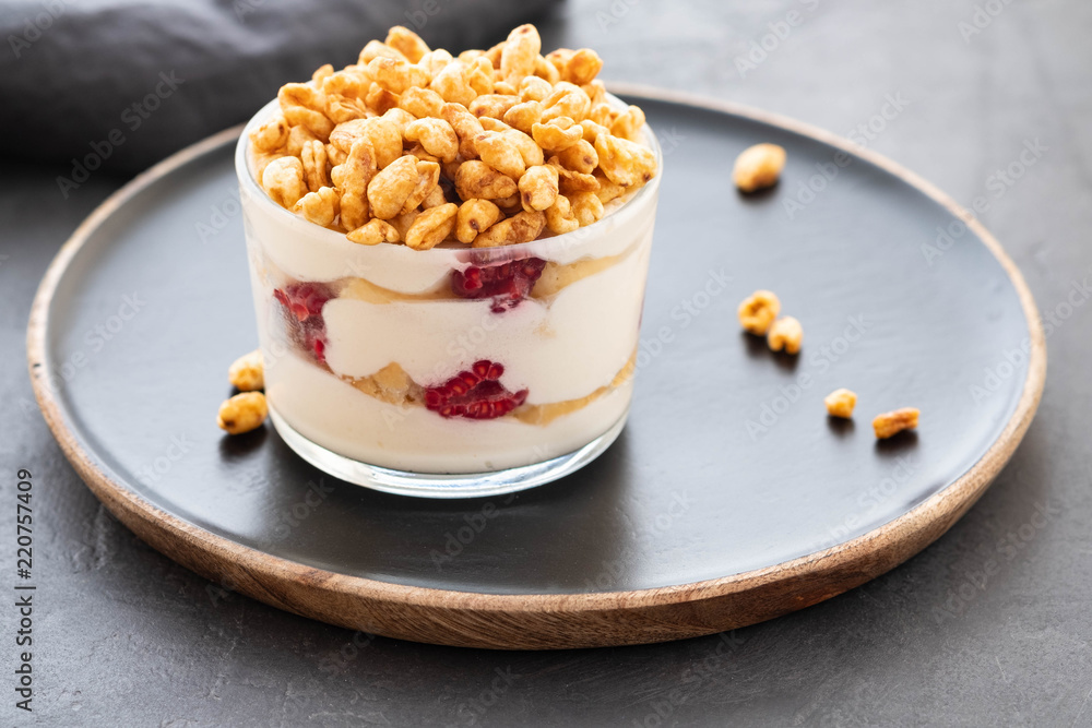 Fresh yoghurt with rasberry in clear glass. Raspberries in white bowl. Healthy morning breakfast. Fresh yoghurt with rasberry in clear glass. Raspberries in white bowl. Healthy morning breakfast.