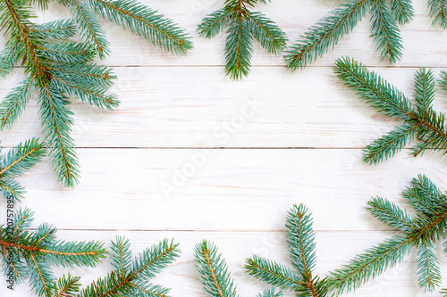 Natural white wooden background with spruce brunches