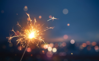 Sparkler with blurred busy city light background