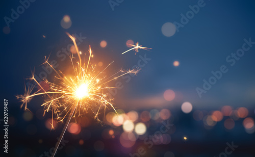Sparkler with blurred busy city light background